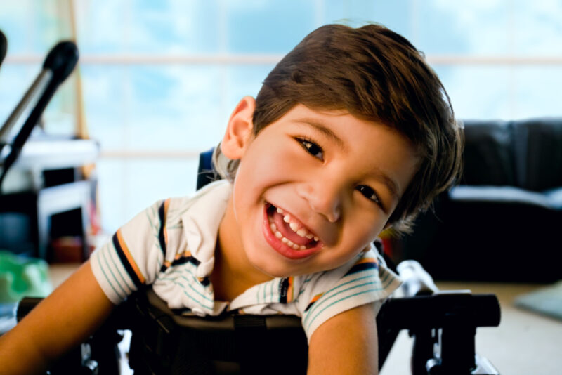 Young boy smiling brightly after children’s dental care.
