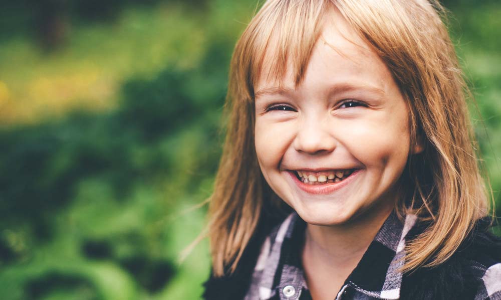 Smiling young girl with bright, healthy teeth.