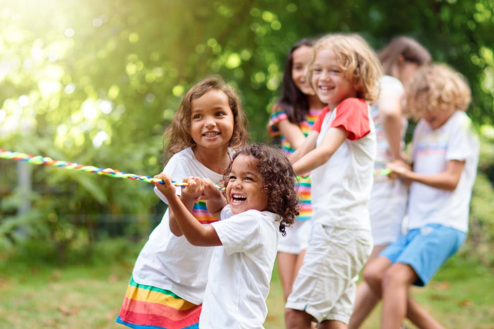 Child playing outdoors symbolizing positive pediatric dental health.