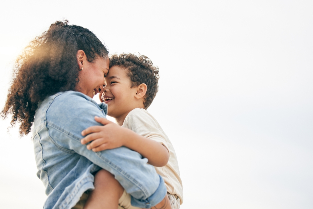 Parent hugging child representing family-focused pediatric dental care.