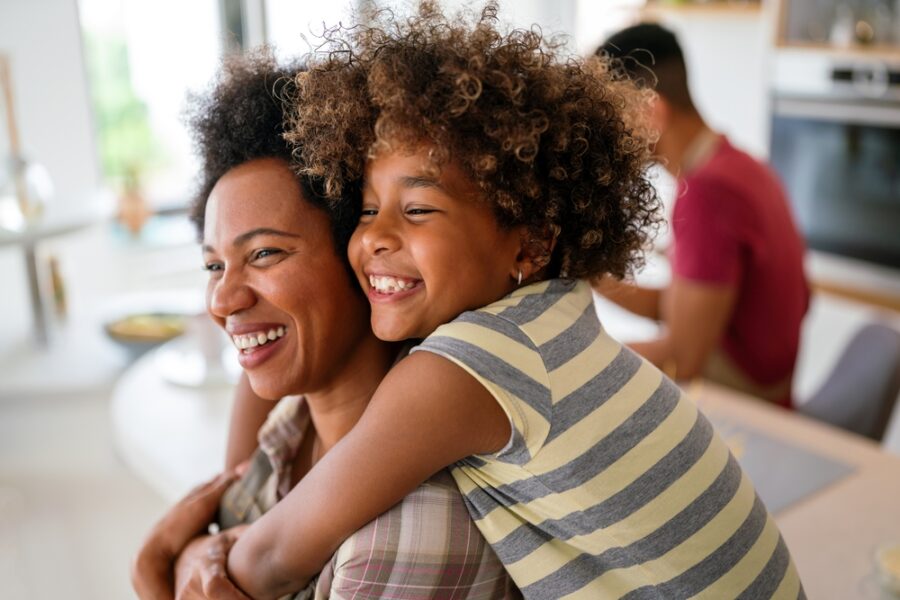 Mother and child smiling during a positive dental care experience.