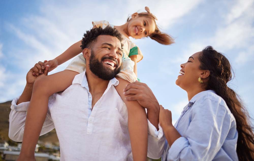 Father lifting child representing joyful pediatric dental care.