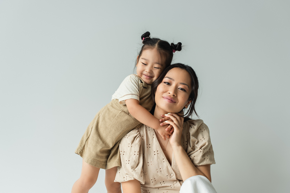 asian toddler hugging mom