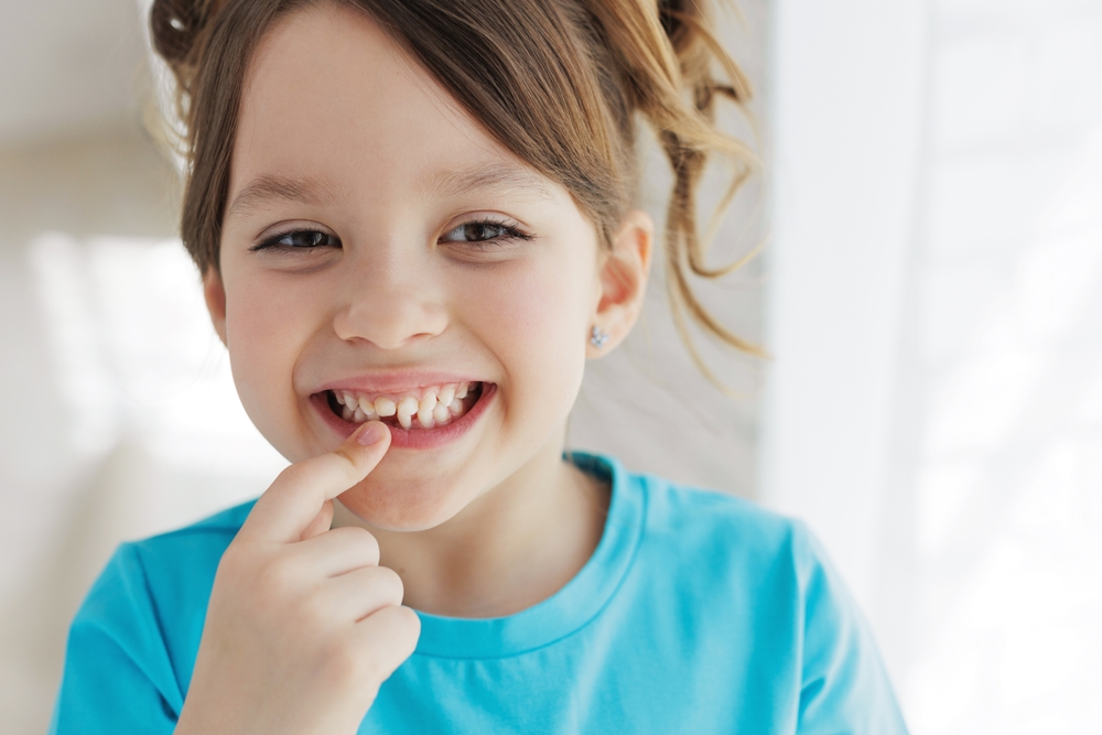 girl lost baby tooth