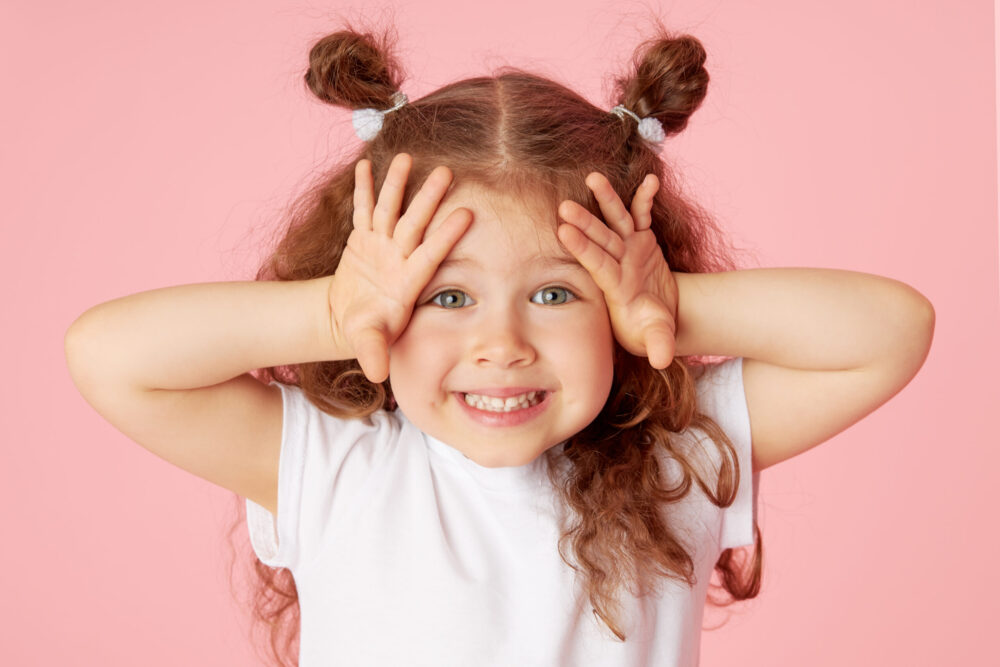 happy little girl showing white smile