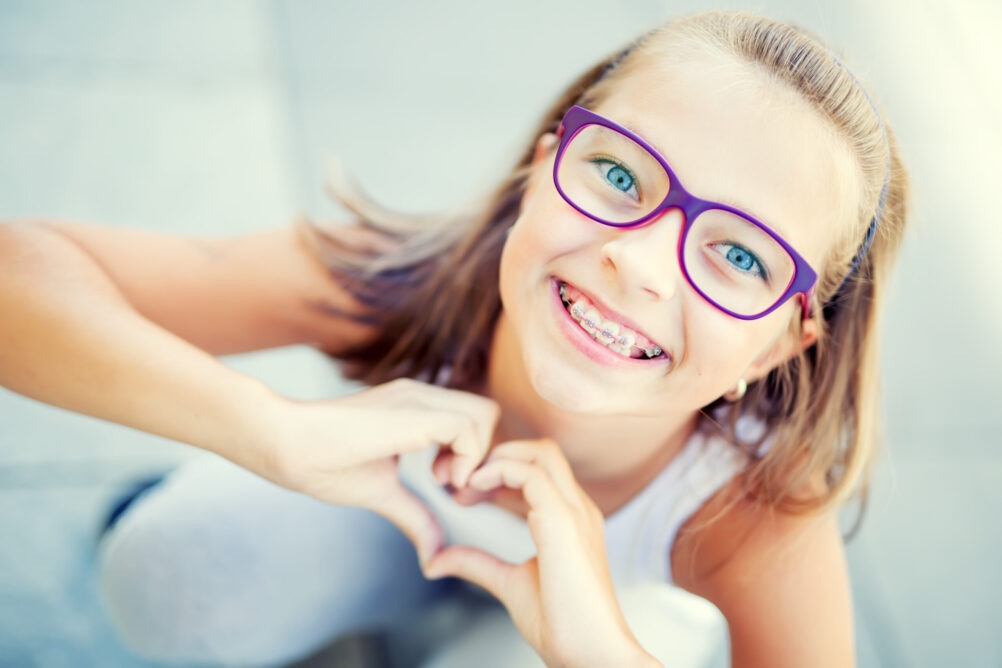 little girl smiling with metal braces