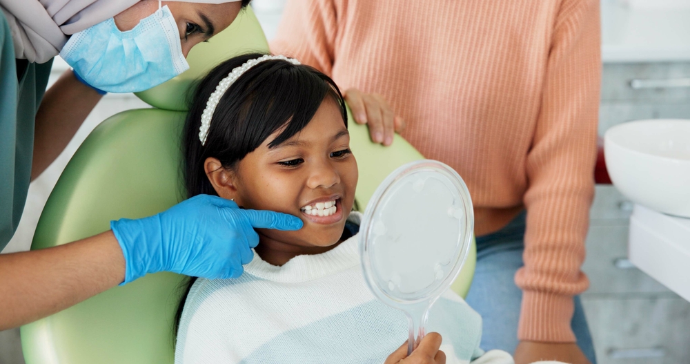 patient staring at smile on hand held mirror